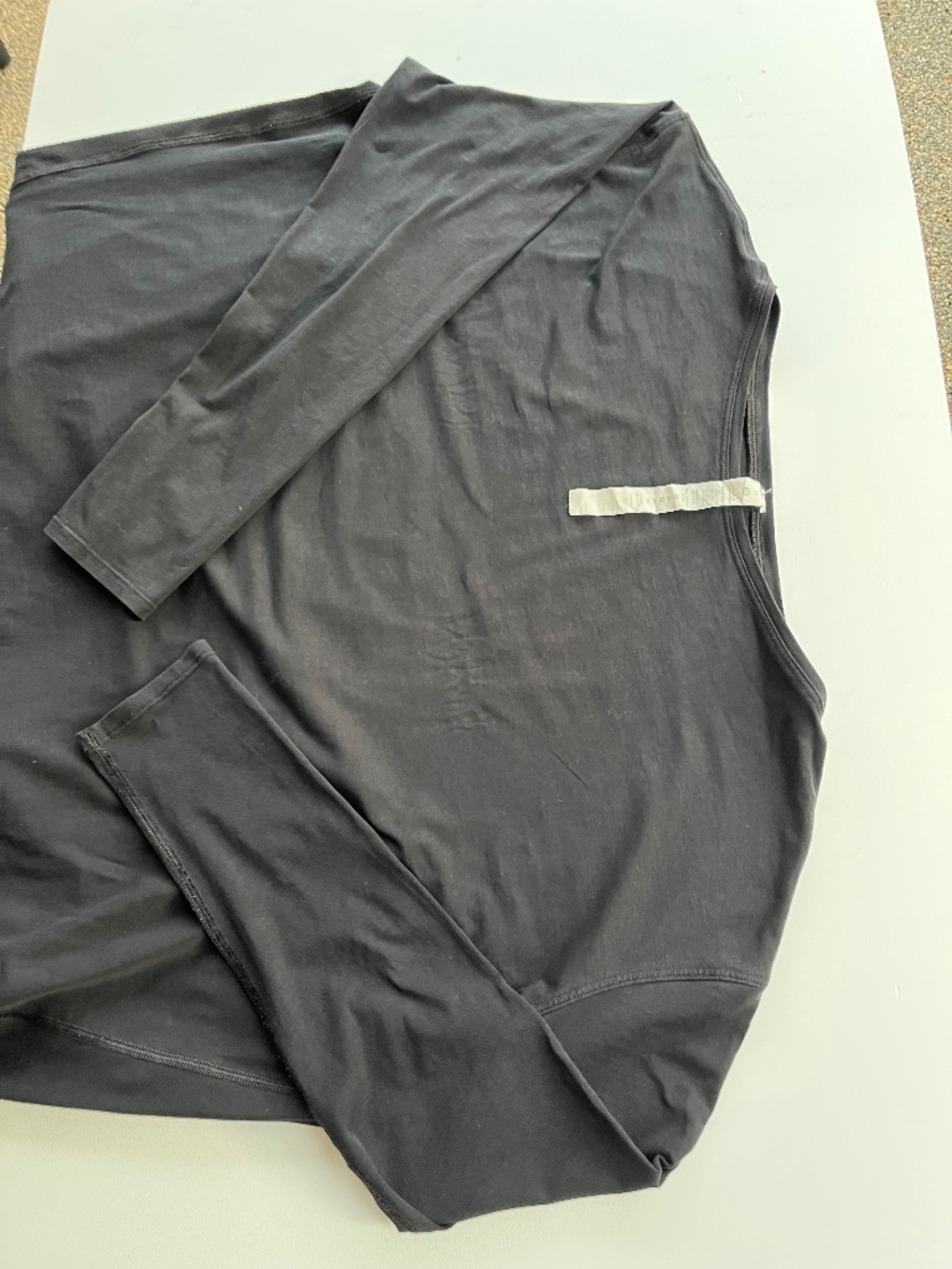 Lululemon athletic black long-sleeve knit top with curved panel seams